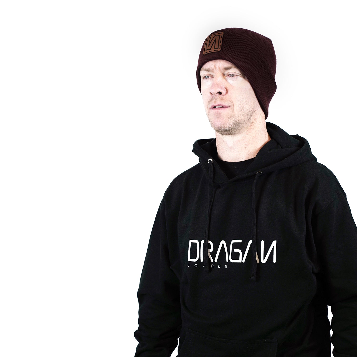 Brinton Gundersen wearing a black hoodie with a Dragan logo on it and a dark red beenie  on a white background